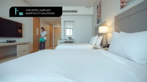 Professional hotel housekeeping staff using eco-friendly hotel cleaning products in a spotless guest room